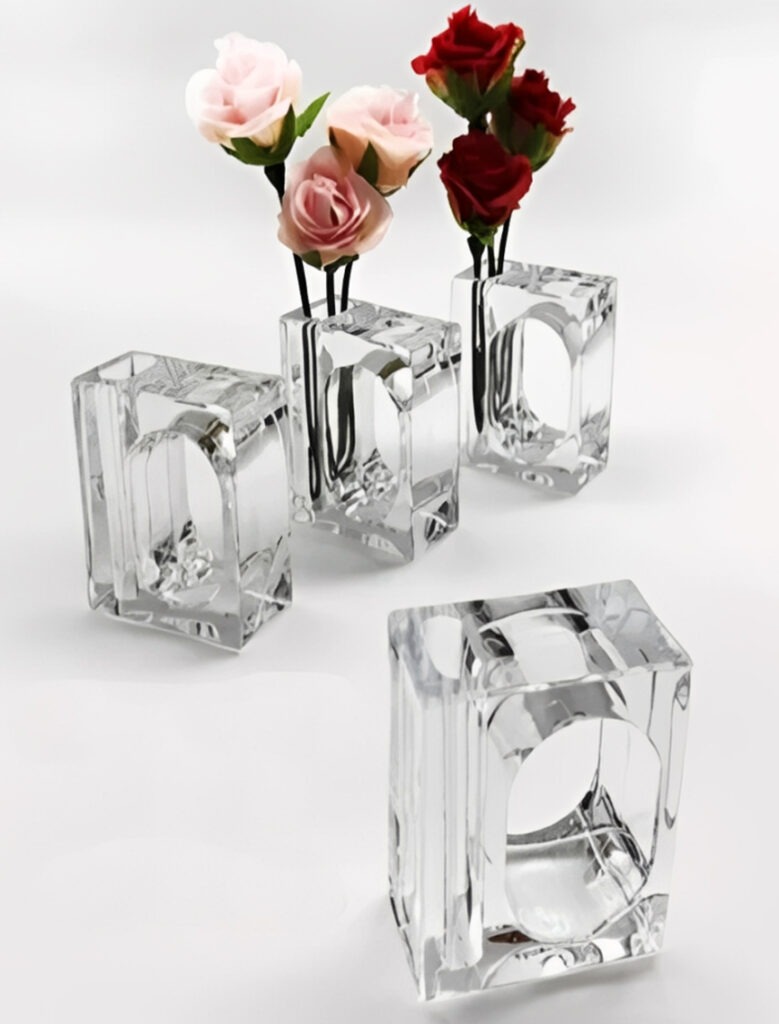 Four transparent glass vases hold pink and red artificial roses. The elegant design highlights floral arrangements, perfect for decorative purposes.