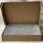 Acrylic serving tray with a bubble wrap and a cardboard box